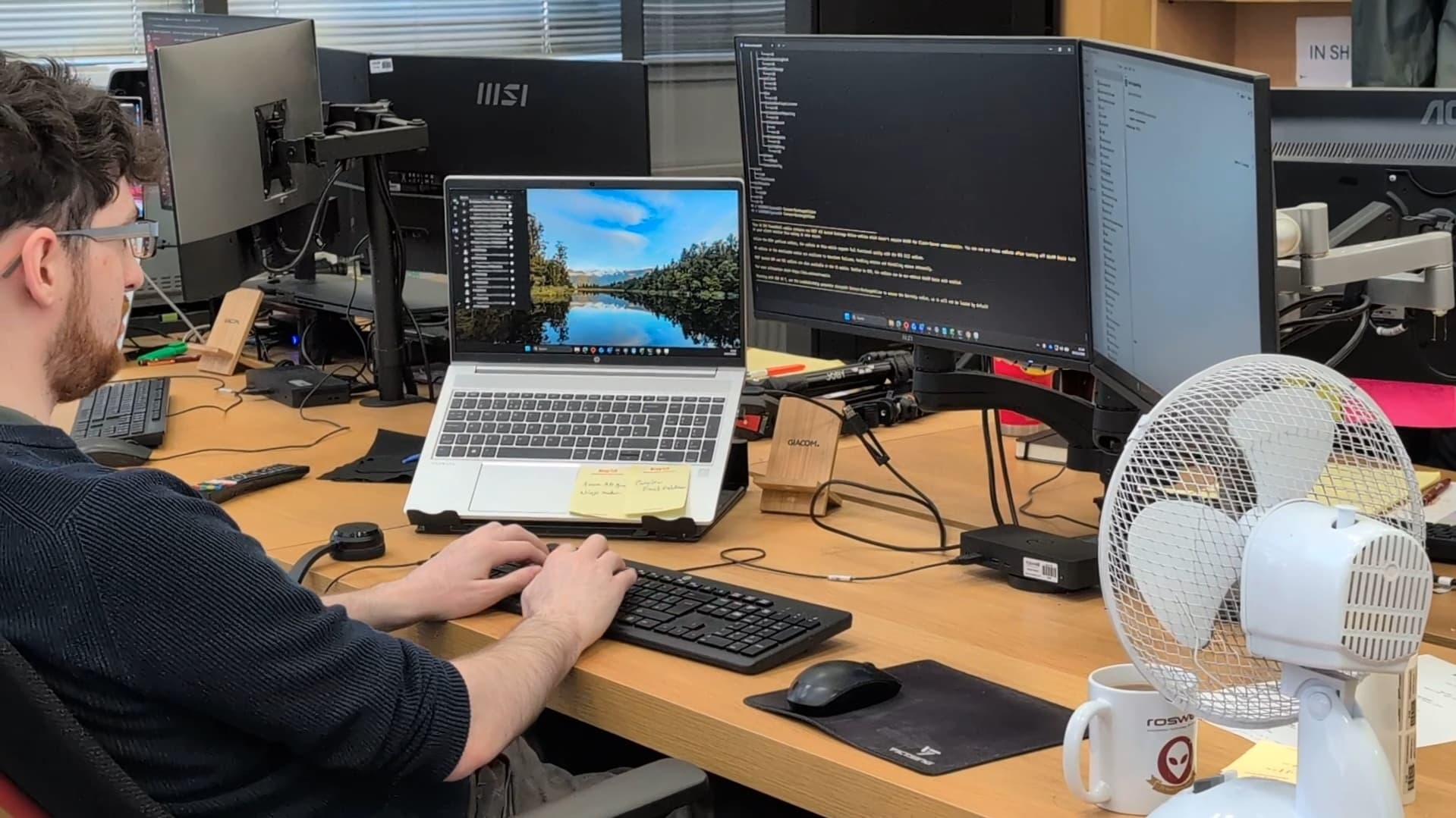 A Roswell IT engineer at his desk writing code